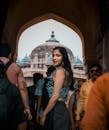 Stylish woman in archway with iconic New Delhi backdrop, capturing the essence of modern Indian fashion.
